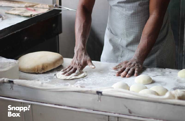 A baker kneading dough