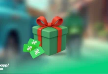 A green gift box with a red ribbon and 3 discount icons beside it