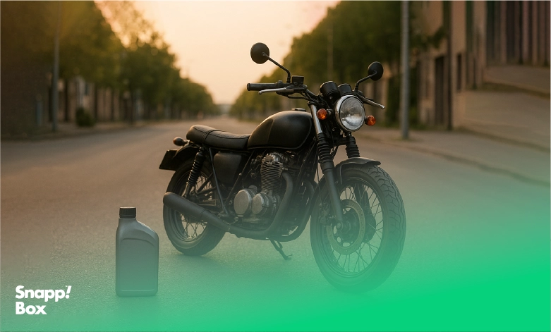 A black motorcycle with a can of motorcycle oil beside it