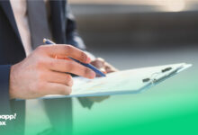 دستان یک مرد که یک چک‌لیست راه‌اندازی کسب‌وکار و یک خودکار را نگه داشته است